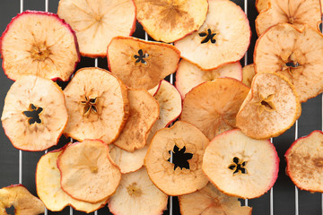 Tasty apple chips on cooling rack, closeup