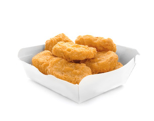 Box with tasty chicken nuggets on white background