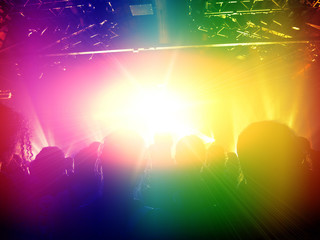 Concert people dancing in colorful stage lights