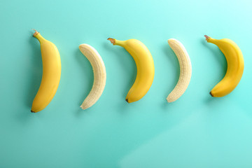 Ripe bananas on color background