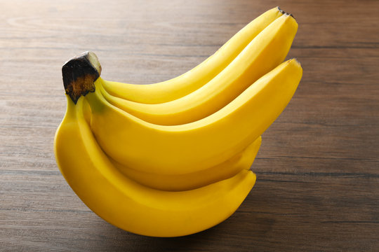 Ripe bananas on wooden background