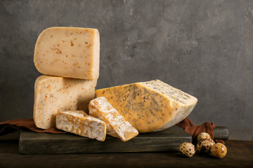 Different kinds of delicious cheese on table
