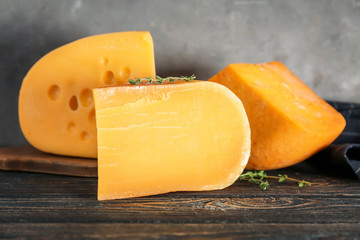 Different kinds of delicious cheese on table