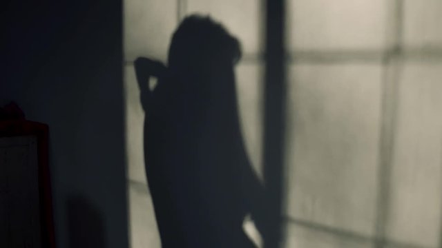 Two silhouettes of smiling loving couple. They are going to kiss each other.
