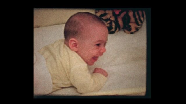 1959 older bother watching 2 month old infant boy in crib