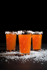orange cocktails, salt, lemon on a dark background
