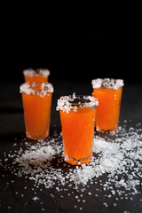 orange cocktails, salt, lemon on a dark background