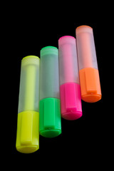 Multicolored highlighters isolated on black background, Highlighter to highlight text, study tools