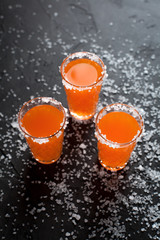 orange cocktails, salt, lemon on a dark background