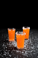 orange cocktails, salt, lemon on a dark background