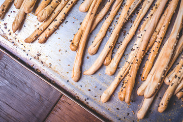 Bread sticks from wheat flour on a baking sheet.