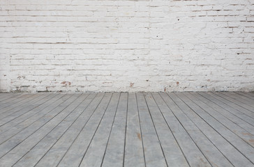 The white background wall and the gray wooden floor