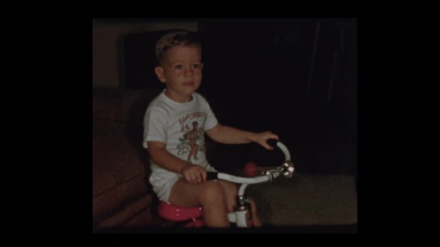 1955 Adorable 50's little boy rides tricycle inside wearing Davy Crockett shirt