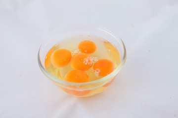 Fresh eggs in a  bowl. Broken eggs with bright yolks.