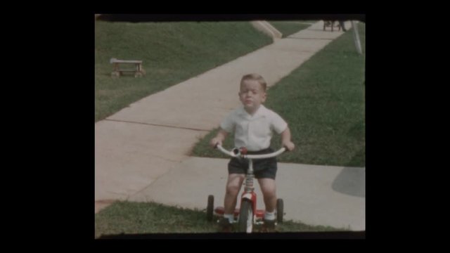 1955 Cute blond boy rides Red tricycle