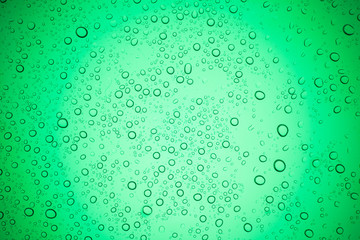 Rain droplets on green glass background, Water drops on glass.