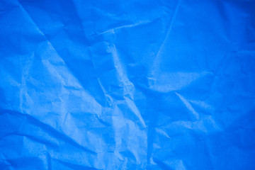 Crumpled blue paper background.