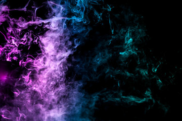 Colorful smoke of blue, pink, green on a black isolated background. Background from the smoke of wipe