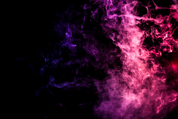 Obraz na płótnie Canvas Colorful smoke of blue, pink, green on a black isolated background. Background from the smoke of wipe