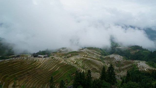 Time lapse of clouds blowing up hillside