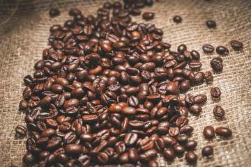 a small handful of fried coffee beans in a bag