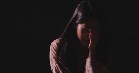Woman crying in the dark