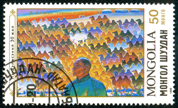 Ukraine - circa 2018: A postage stamp printed in Mongolia shows Man, Bactrian camels. Series: Aspects of a Cooperative Settlemen. Circa 1989.