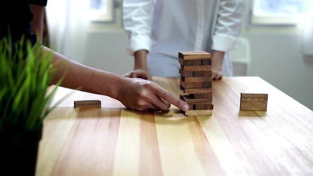 teamwork making a pyramid with empty wooden cubes. Business concept with step-by-step for a firm basis.