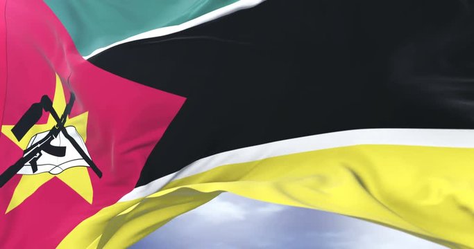 Mozambique flag waving at wind in slow in blue sky, loop