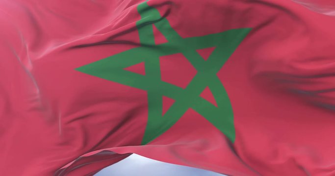 Morocco flag waving at wind in slow in blue sky, loop