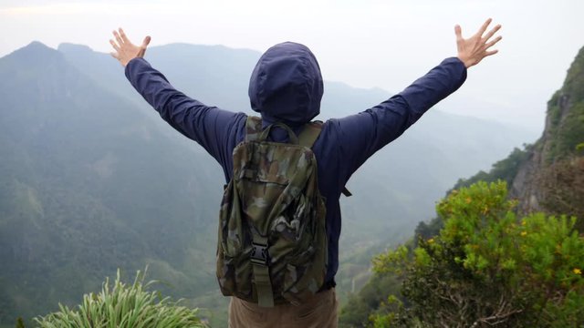 Happy Hiker Man Spreading Arms On The Top Of Mountain. Slow Motion. 4K. 