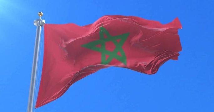 Flag of Morocco waving at wind in slow in blue sky, loop