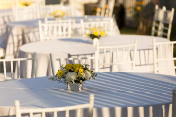 Flowers decoration on white table outdoor in  wedding reception