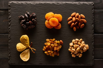 Dried fruits and nuts on slate plate