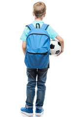 schoolboy with backpack and a football ball view from behind on a white background