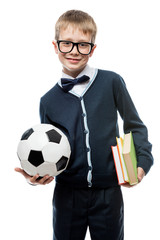 vertical portrait of a schoolboy with a ball and textbooks, a schoolboy is isolated