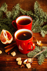 Fototapeta na wymiar Christmas hot cranberry tea, cookies and light bokeh, closeup