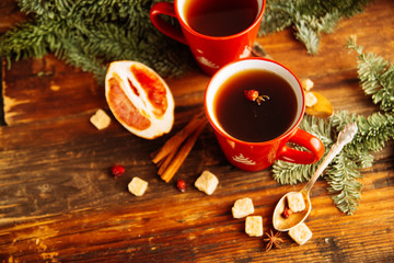 Christmas hot cranberry tea, cookies and light bokeh, closeup