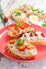 Sandwiches or baguette with mackerel or tuna fish paste on plate, healthy nutrition concept