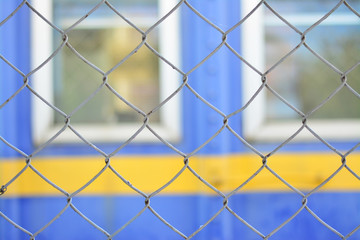 Fototapeta premium Mesh made of steel wire with window background.