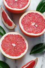 Close-up of grapefruits on white marble.
