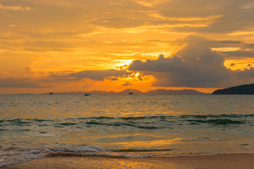 bright orange sunset with beautiful clouds over the sea of Thailand, Krabi province