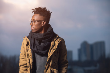 Portrait of black man in winter wear against city background