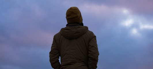 Thoughtful human silhouette looking at sky