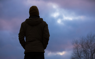 Thoughtful human silhouette looking at sky