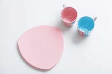 Fototapeta premium pink and blue cups on white background