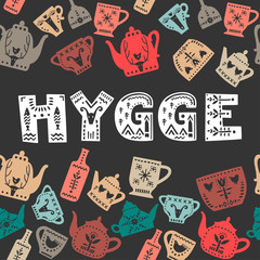 Vector hand drawn poster with decorative inscription "Hygge" and pattern made of teapots  and mugs on a black bakground.