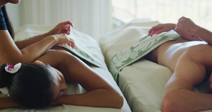 Couple relaxing enjoying massage together at the spa