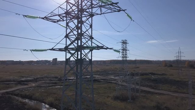 Aerial footage. Flying up the high voltage electricity tower and power lines