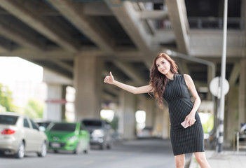 Young Beautiful Asian Straight Hair Woman Asking for a Taxi Raising her Arms